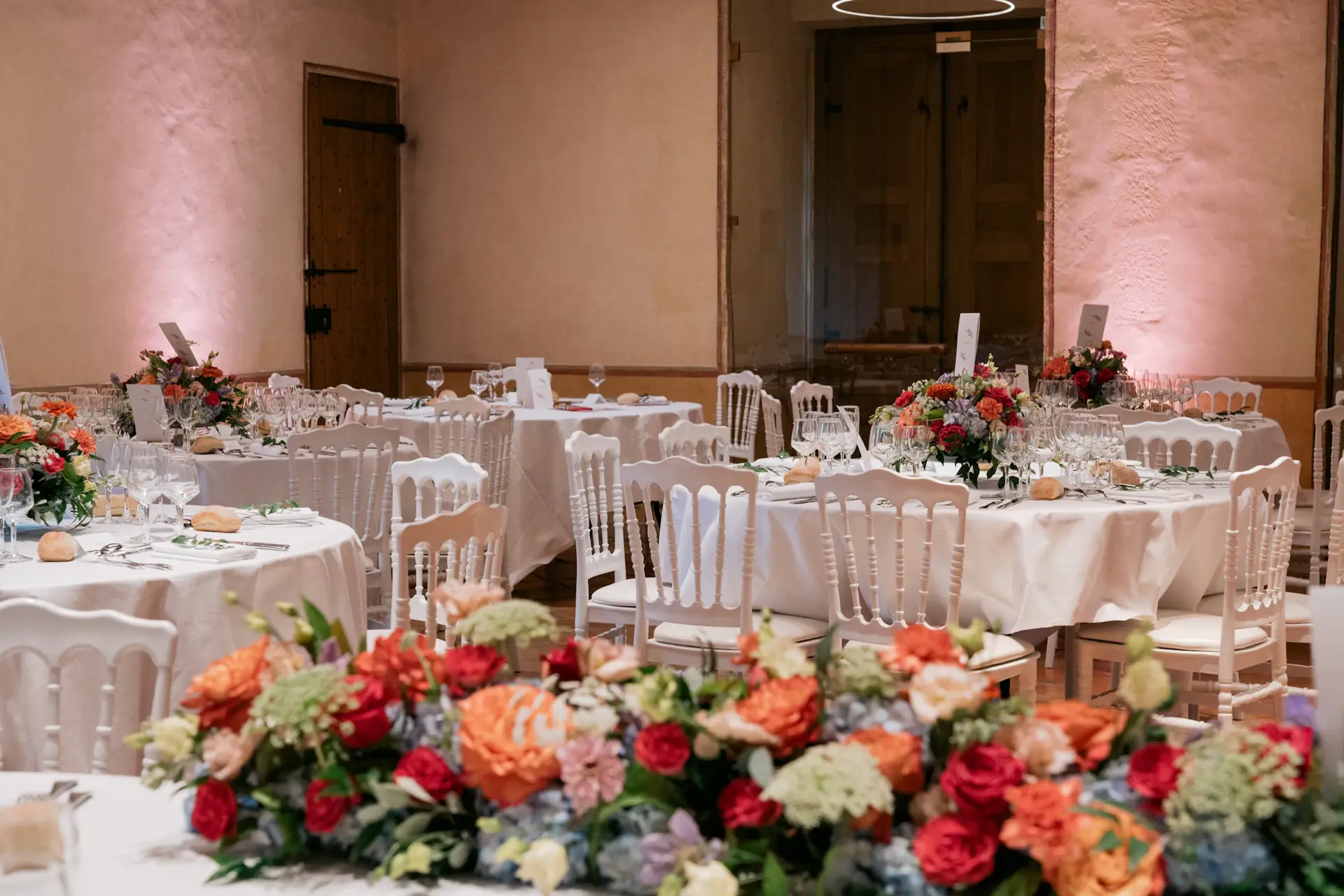 Wedding reception tables with white linen and floral centrepieces